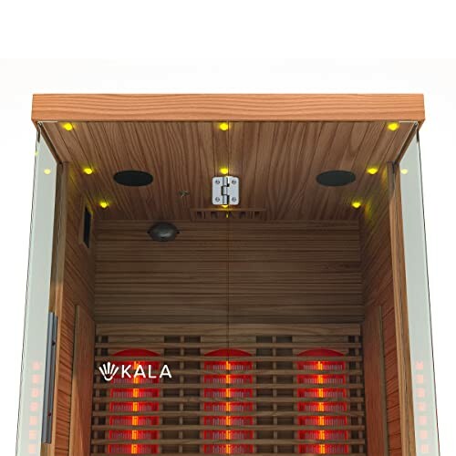 Interior view of an infrared sauna with red heating elements and wooden panels