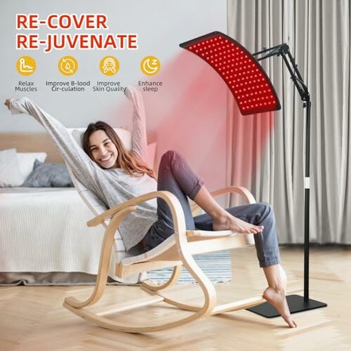 Woman relaxing in a chair under a red light therapy lamp.