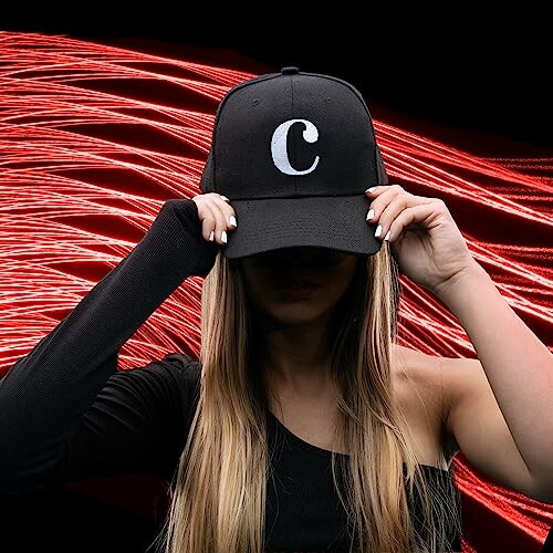 Woman in black cap with red light background